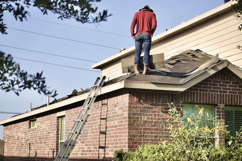 Professional roofer working on a residential roof in Manatawny
